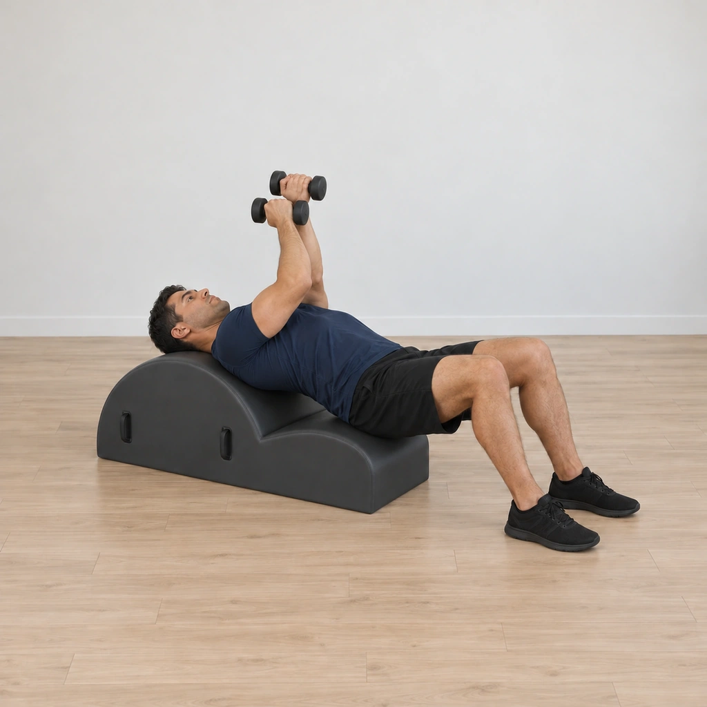His overlapped elbows bend and stack down toward his center as his head reaches into the barrel, the weights held close, completing the hug.