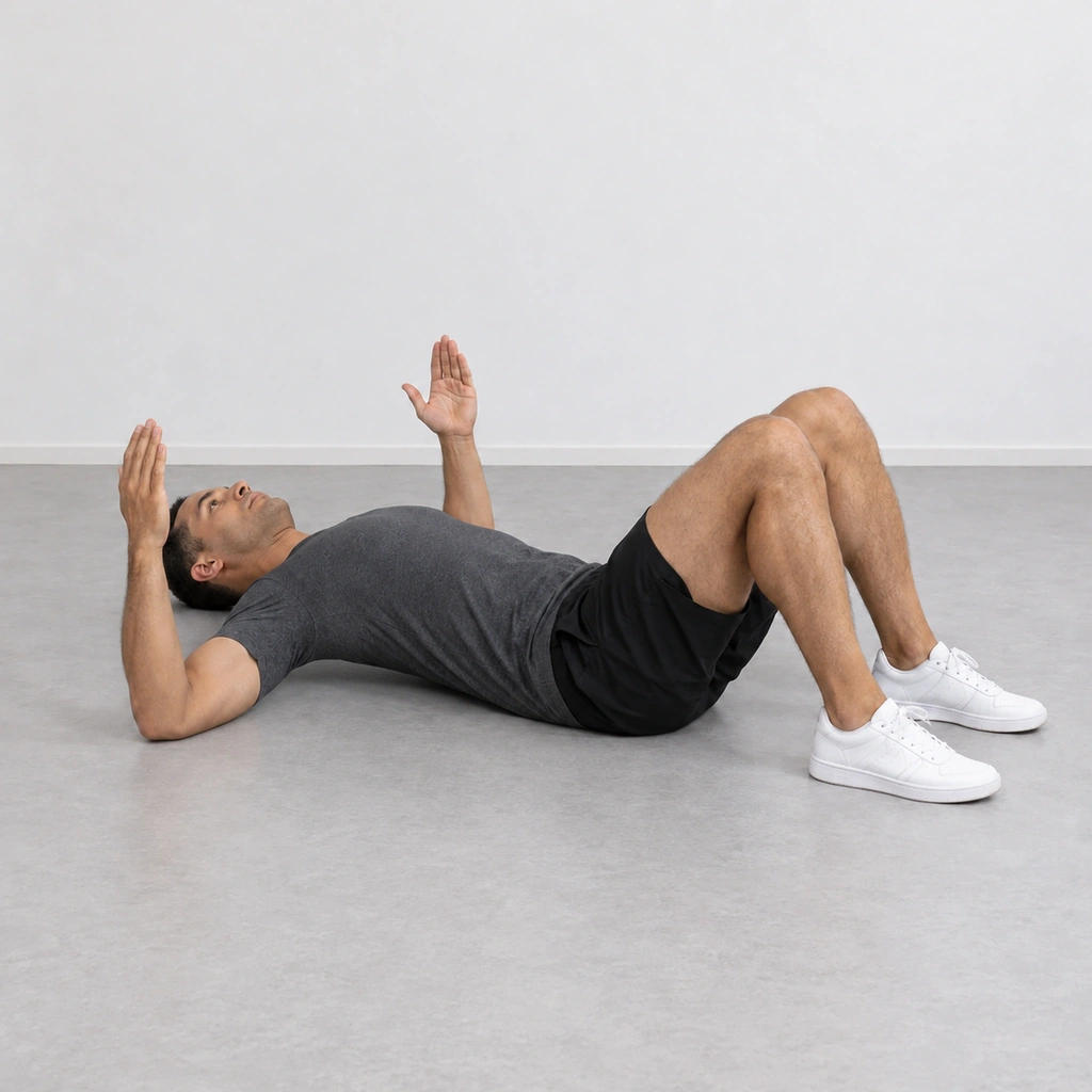 The same man with his elbows still on the floor and his upper back and shoulders lifted a little way off the floor, his head resting and his hips and feet down.