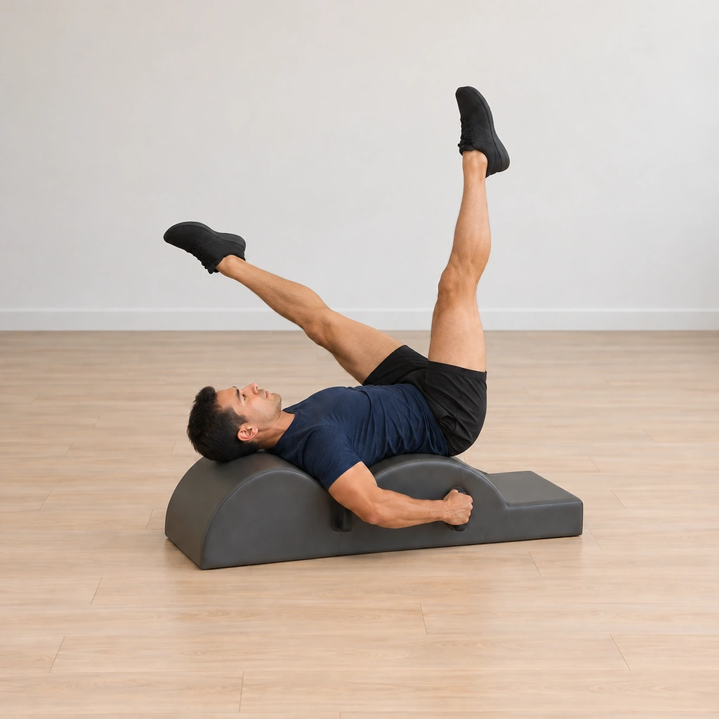 One of his legs reaches further over toward the barrel while the other reaches up toward the ceiling, his elbows wide, his neck long and his hands on the handles.