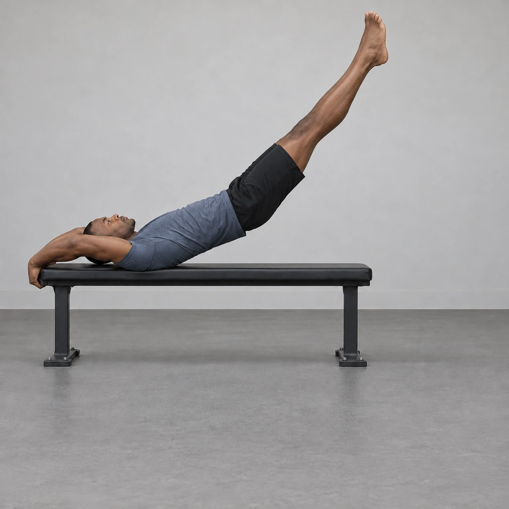 A man on a bench with his whole body lifted as one straight line, weight on the upper back, body angled toward vertical.