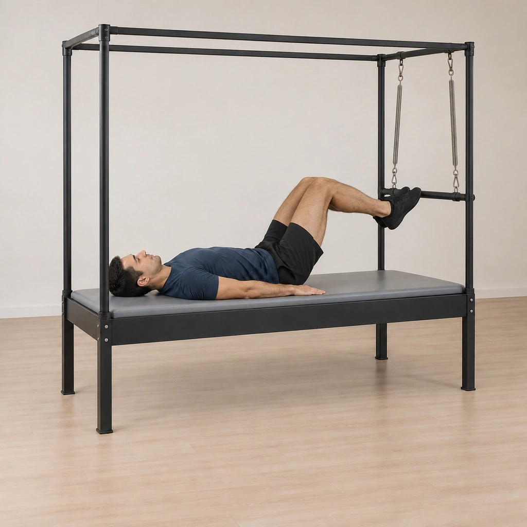 The balls of his feet are on the push-thru bar with his heels together and feet pointed, his legs bent so the bar travels toward him, his tailbone still down.