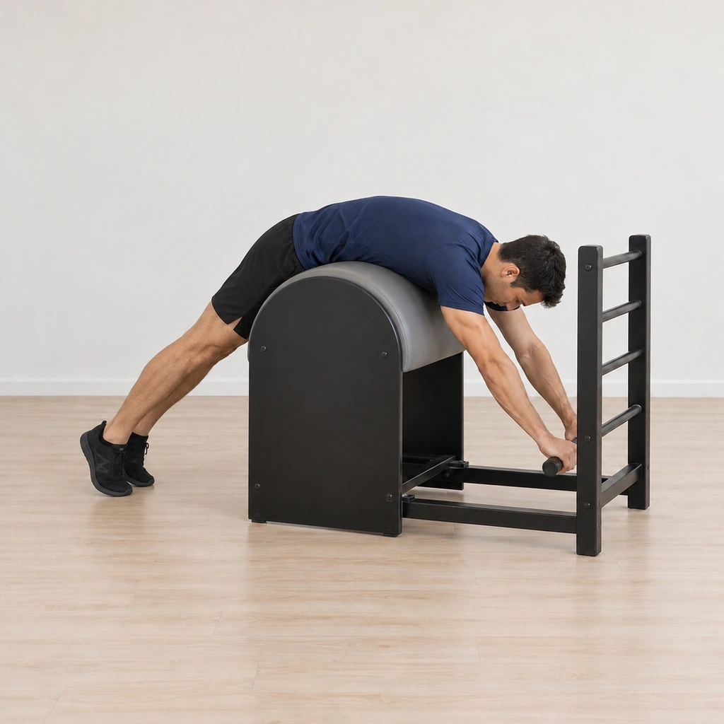 His body lengthens over the barrel - arms reaching into the rung, legs reaching out long - the two-way stretch active over the apex.