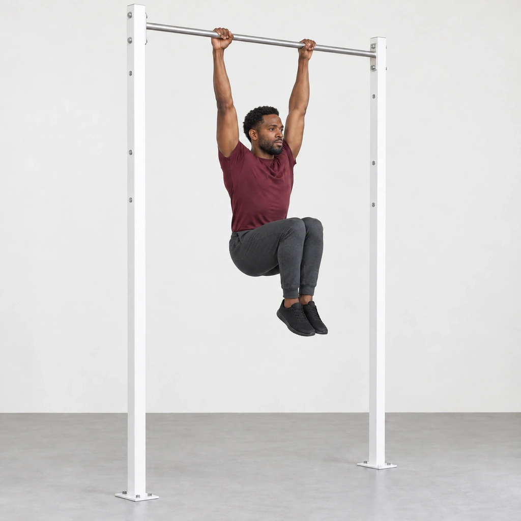 Man hanging from a pull-up bar with straight arms and both bent knees raised in front of him above hip height.