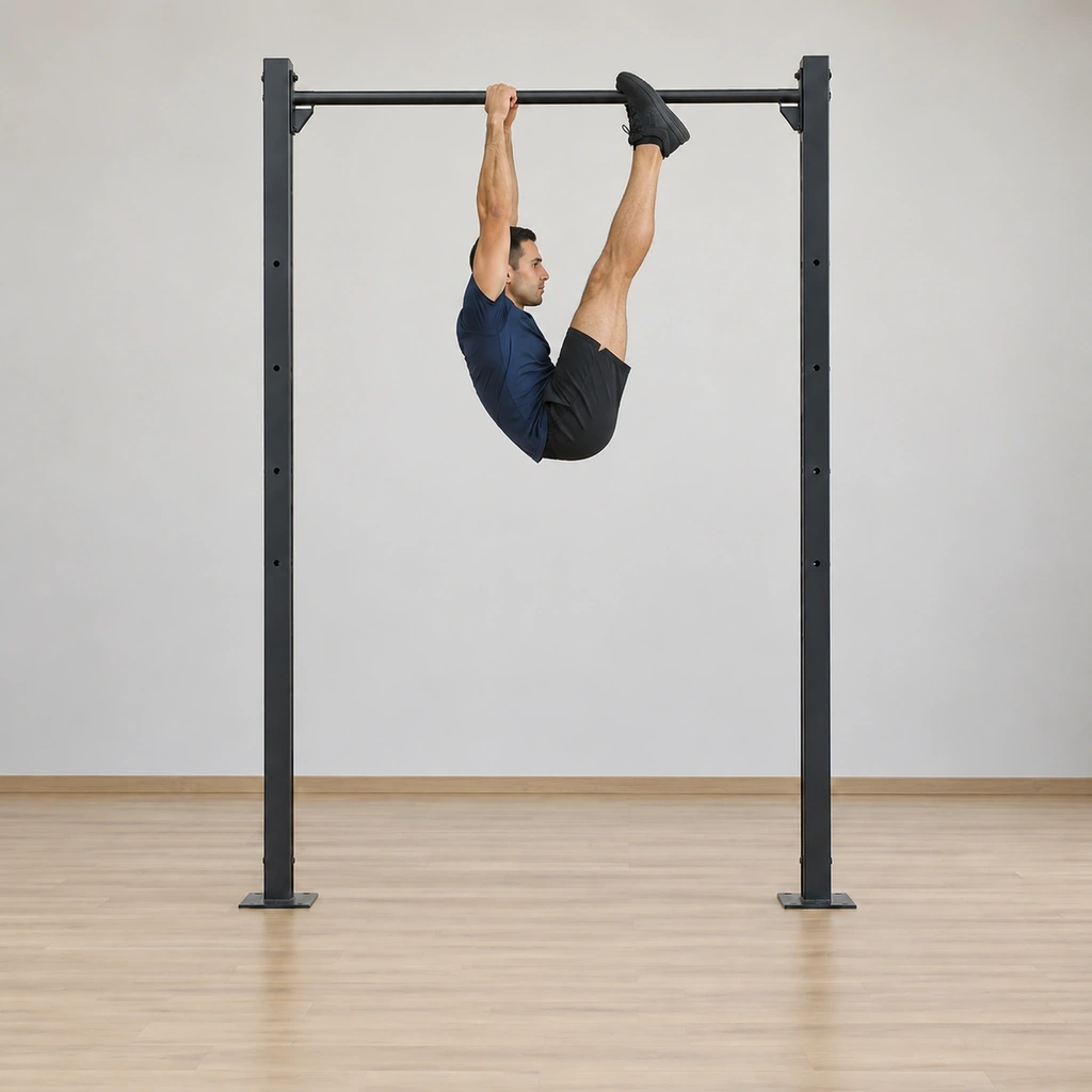 He is mid-pull: straight legs rising together in front of him toward the bar, hips rolling up from the abdominal contraction, knees locked, arms still fully extended.