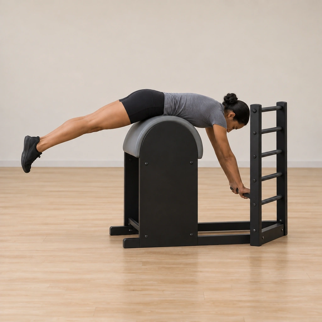 Her straight arms press into the bottom rung working from her upper back as if standing on them, her legs still reaching long and together, head down, waist at the apex.