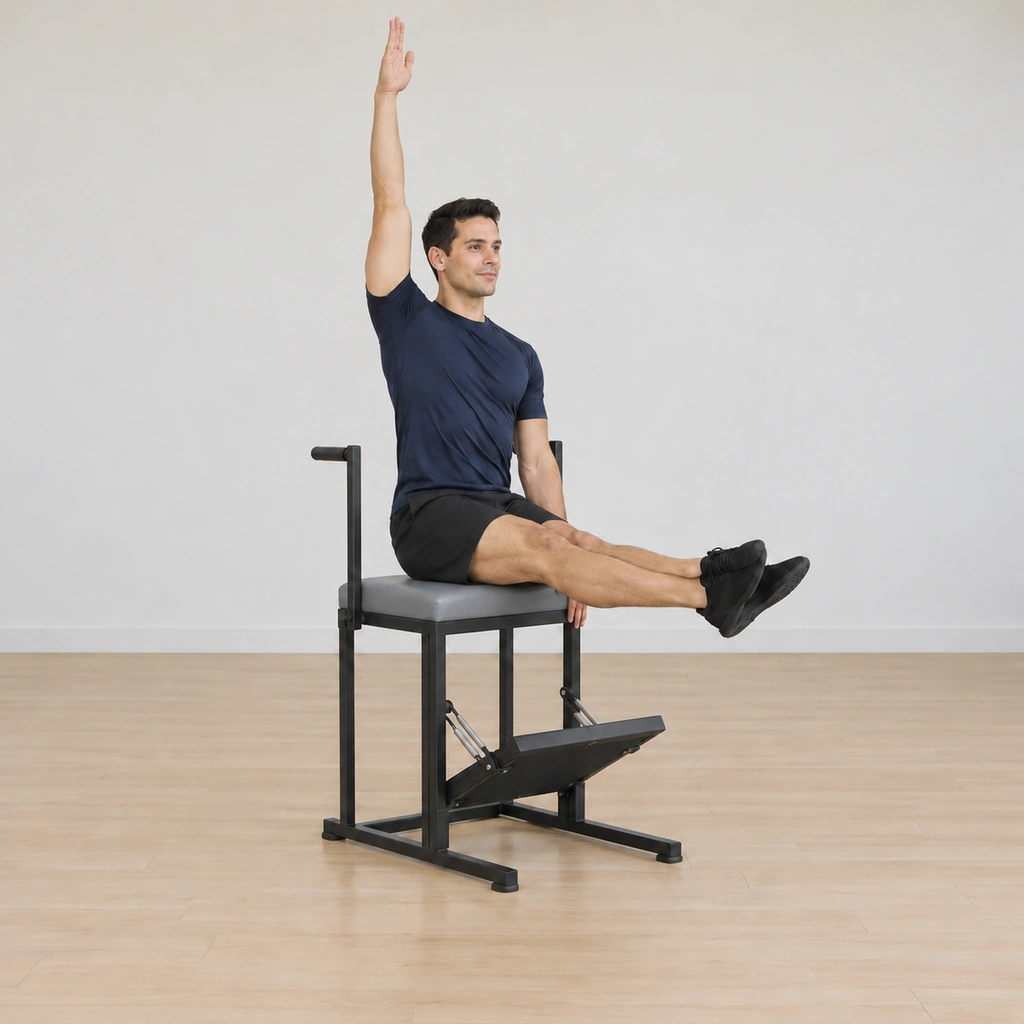 He is lifted tall from his seat on the chair top, his spine lengthened upward, both side bodies long, his outside arm high and his inside arm low, his legs still held straight out in front.