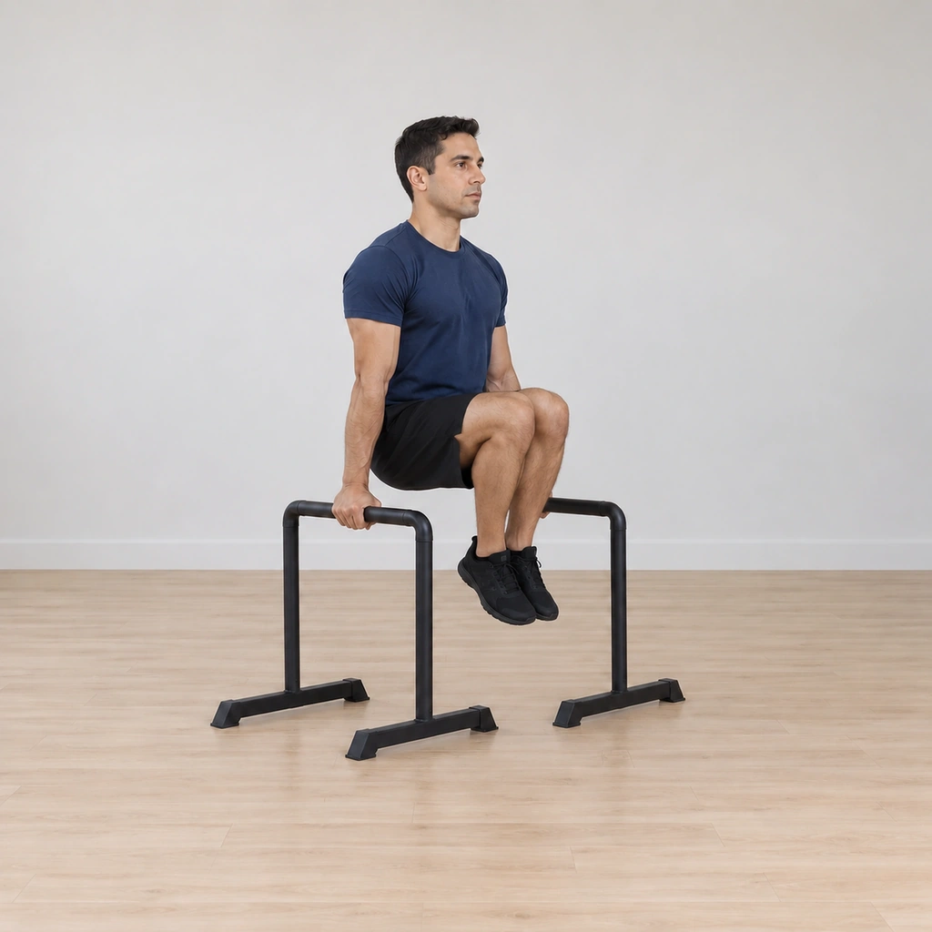 He lowers both knees under control toward the hanging position, arms locked, feet still clear of the floor.
