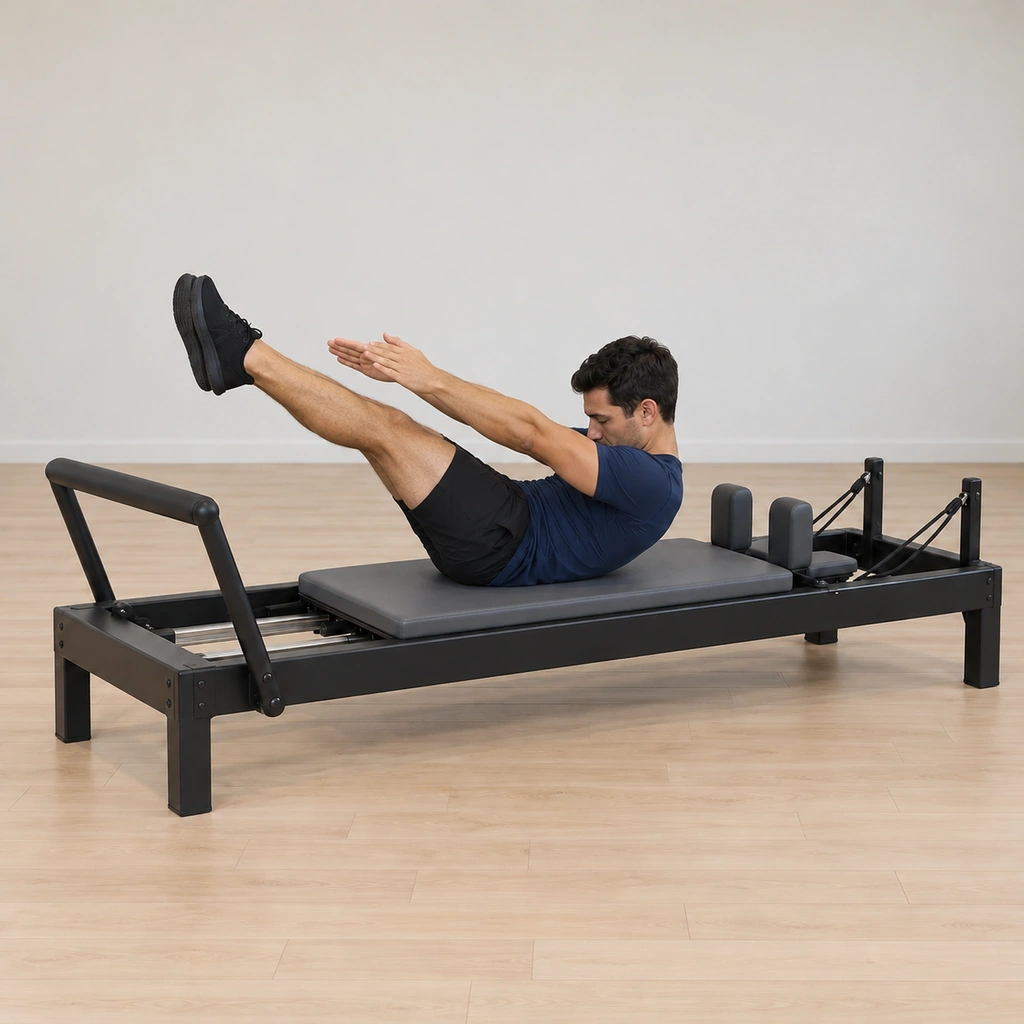 The man stays in his high abdominal curl while both arms and both legs extend forwards away from the ball - the legs reaching out and the arms reaching forward - the curl never released.