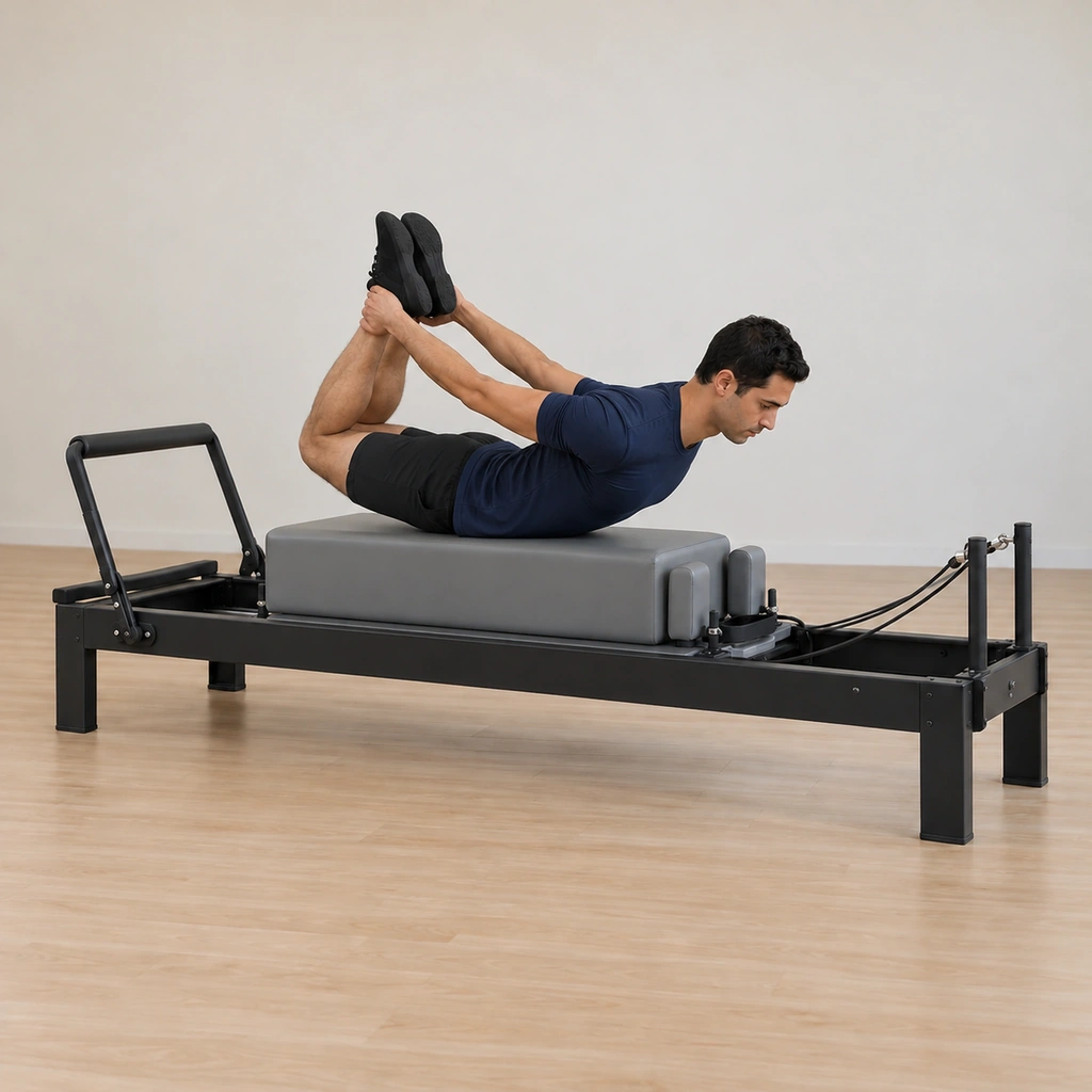 He is mid-rock, the held-grip extension tilting his weight forward along the box while the knees stay pressed away and the spine stays long.