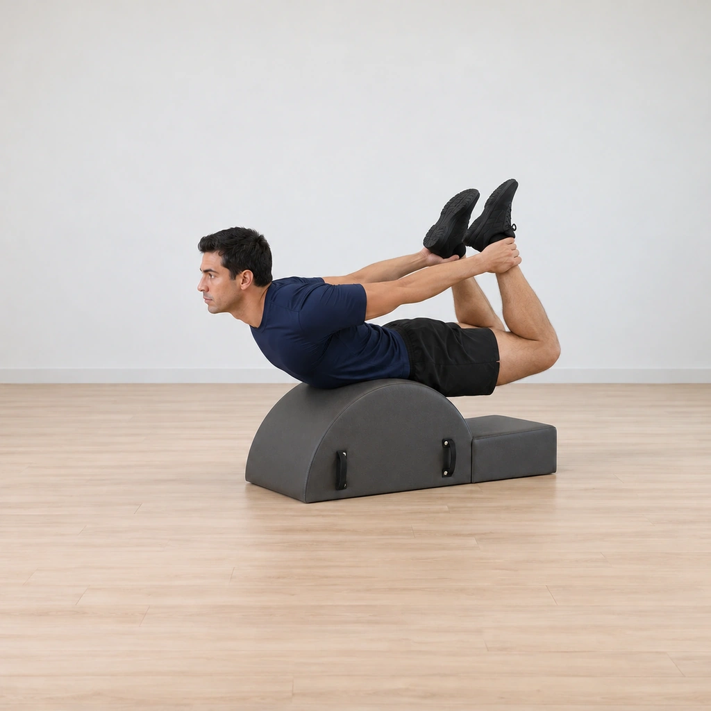 His knees bend together as his arms reach back, both hands closing on his ankles over the corrector's hump.