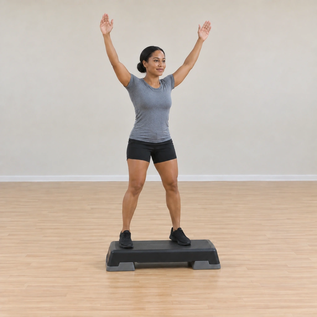 She is mid-jumping-jack on the platform, feet apart and arms swept out, the platform under her and its edges clear.