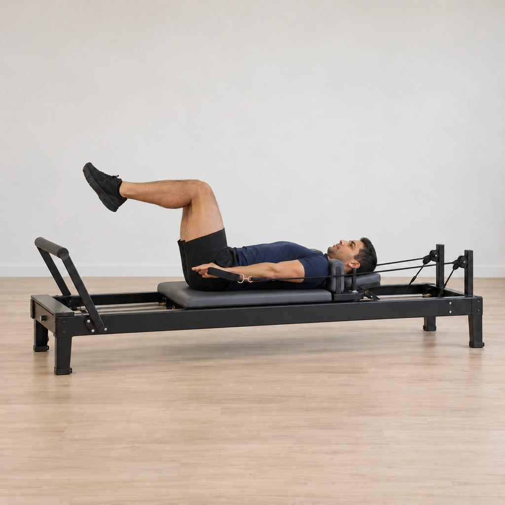 His arms have lengthened down to the level of the carriage beside his hips, still straight, the ropes under full tension.