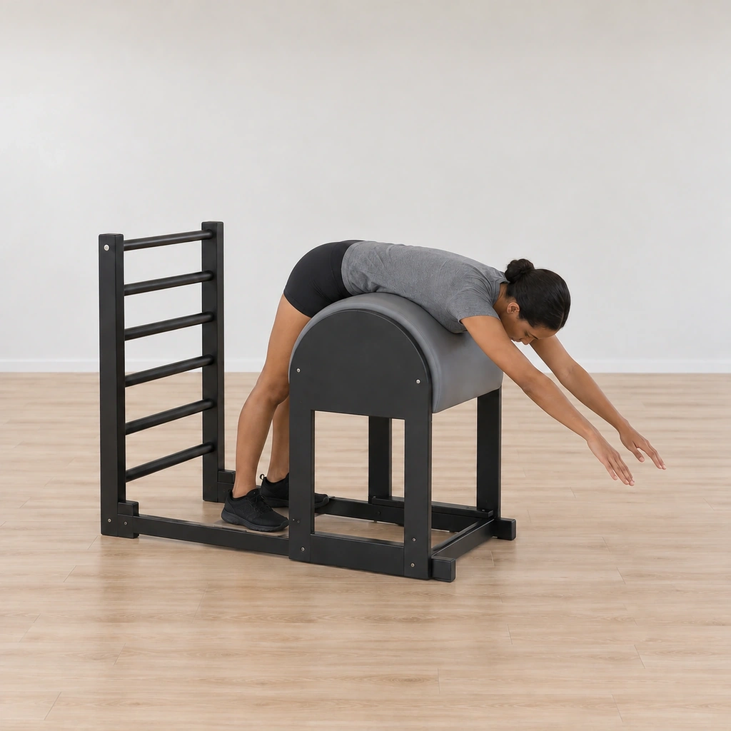 She is reaching long back down into the drape - the torso folding back over the apex under control, arms still long.